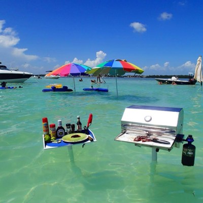 Grill stuck in sand and rising above shallow water