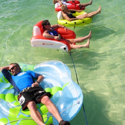People sitting in innner tubes in the water