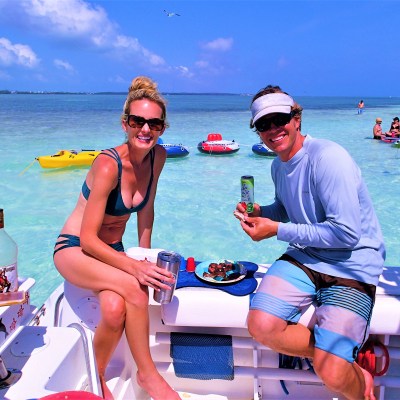 man and women sitting on back of a boat