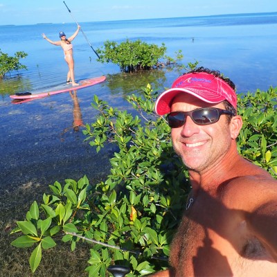 Man taking selfie in mangroves with paddleboard