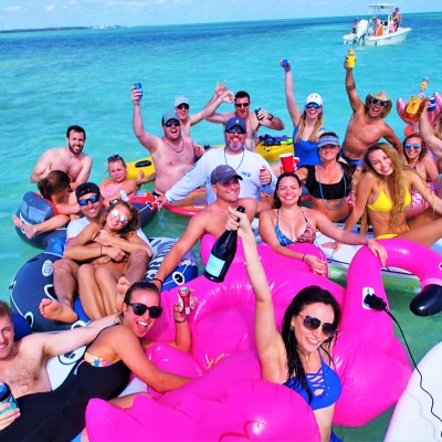Large group of people sitting on floats in the water
